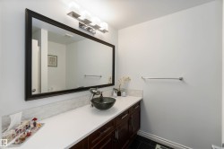 Bathroom featuring vanity and dark tile patterned flooring - 