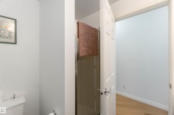Bathroom with a stall shower and light wood finished floors - 