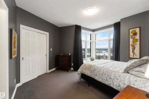 Carpeted bedroom with a textured ceiling and baseboards - 1101 9020 Jasper Avenue, Edmonton, AB - Indoor Photo Showing Bedroom