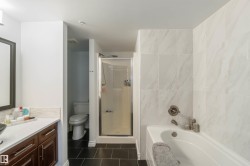 Bathroom with a stall shower, a bath, vanity, and dark tile patterned floors - 