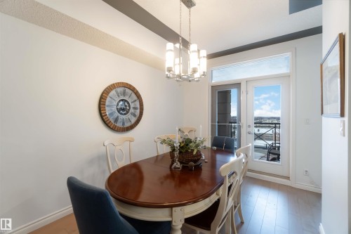 Dining space with a chandelier and wood finished floors - 1101 9020 Jasper Avenue, Edmonton, AB - Indoor Photo Showing Dining Room