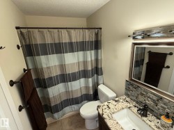 Bathroom with vanity, curtained shower, tasteful backsplash, a textured ceiling, and light tile patterned floors - 