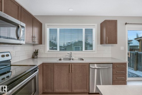 6862 21A Avenue Sw, Edmonton, AB - Indoor Photo Showing Kitchen With Stainless Steel Kitchen With Double Sink