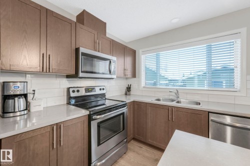 6862 21A Avenue Sw, Edmonton, AB - Indoor Photo Showing Kitchen With Stainless Steel Kitchen With Double Sink