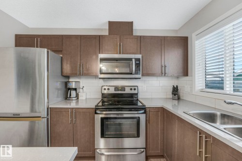 6862 21A Avenue Sw, Edmonton, AB - Indoor Photo Showing Kitchen With Stainless Steel Kitchen With Double Sink
