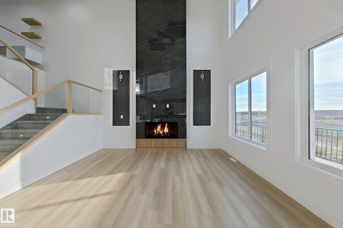 144 Edgewater Cir, Leduc, AB - Indoor Photo Showing Other Room With Fireplace