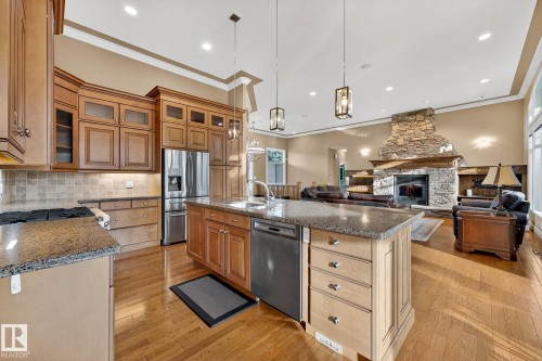 25 53522 Rge Road 274, Rural Parkland County, AB - Indoor Photo Showing Kitchen With Fireplace With Upgraded Kitchen
