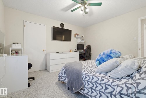 Carpeted bedroom with a ceiling fan and a textured ceiling - 205 11440 40 Ave, Edmonton, AB - Indoor Photo Showing Bedroom