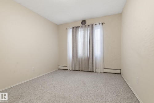 Unfurnished room featuring carpet flooring and baseboards - 205 11440 40 Ave, Edmonton, AB - Indoor Photo Showing Other Room