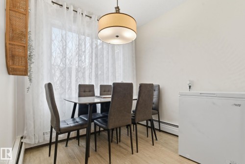 Dining space featuring a baseboard radiator and light wood-type flooring - 205 11440 40 Ave, Edmonton, AB - Indoor Photo Showing Dining Room