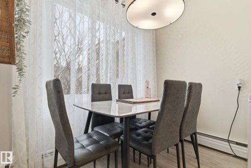 Dining room featuring light wood-style floors and a baseboard heating unit - 205 11440 40 Ave, Edmonton, AB - Indoor Photo Showing Dining Room