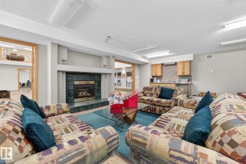 418 200 Bethel Drive, Sherwood Park, AB - Indoor Photo Showing Living Room With Fireplace