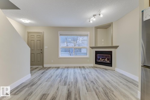 1820 34 Avenue, Edmonton, AB - Indoor Photo Showing Living Room With Fireplace