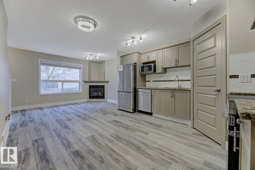 1820 34 Avenue, Edmonton, AB - Indoor Photo Showing Kitchen With Fireplace
