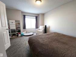 Bedroom with a textured ceiling and carpet - 