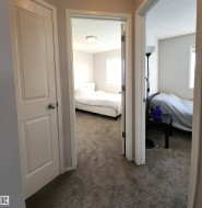 Bedroom with dark colored carpet and a textured ceiling - 