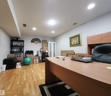 Office with a textured ceiling, light wood-style flooring, and recessed lighting - 
