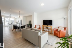 Living room with light wood-type flooring and recessed lighting - 