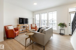 Living room with light wood-style floors and baseboards - 