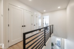 Corridor featuring an upstairs landing, light wood-style floors, and recessed lighting - 