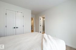 Bedroom featuring a closet, wood finished floors, and ensuite bath - 