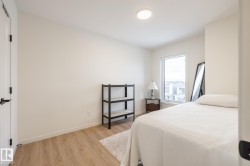 Bedroom featuring light wood finished floors and baseboards - 