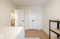 Bedroom featuring light wood-style floors and a closet - 