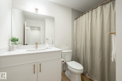 Bathroom with a shower with curtain, vanity, and light wood-type flooring - 