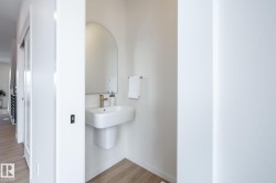 Bathroom with light wood-style flooring and baseboards - 