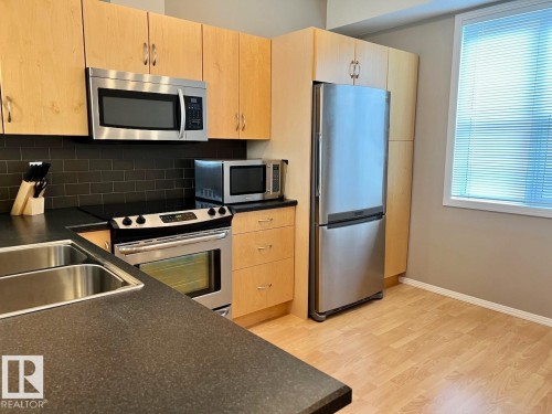 400 9940 Sherridon Drive, Fort Saskatchewan, AB - Indoor Photo Showing Kitchen With Stainless Steel Kitchen With Double Sink