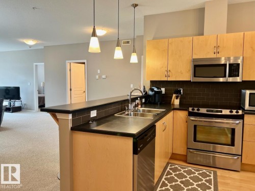 400 9940 Sherridon Drive, Fort Saskatchewan, AB - Indoor Photo Showing Kitchen With Stainless Steel Kitchen With Double Sink