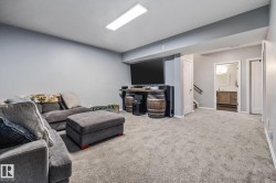Living area featuring carpet flooring and stairway - 