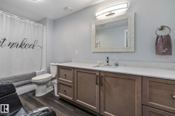 Full bath with vanity, dark wood-type flooring, and shower / bathtub combination with curtain - 