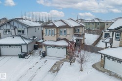 View of front of property featuring a residential view and a garage - 