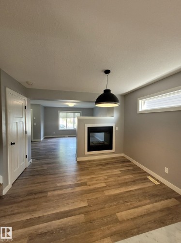 157 Radcliffe Wynd, Fort Saskatchewan, AB - Indoor Photo Showing Other Room With Fireplace