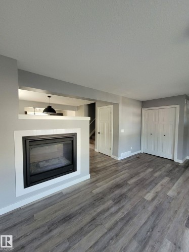 157 Radcliffe Wynd, Fort Saskatchewan, AB - Indoor Photo Showing Living Room With Fireplace