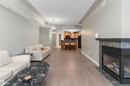 402 9020 Jasper Avenue, Edmonton, AB - Indoor Photo Showing Living Room With Fireplace
