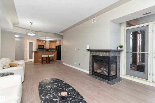 402 9020 Jasper Avenue, Edmonton, AB - Indoor Photo Showing Living Room With Fireplace
