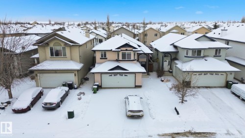 View of front of house with a residential view and a garage - 3316 24 Avenue, Edmonton, AB - Outdoor With Facade