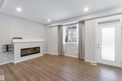 54 2072 Wonnacott Way, Edmonton, AB - Indoor Photo Showing Living Room With Fireplace