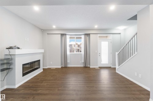54 2072 Wonnacott Way, Edmonton, AB - Indoor Photo Showing Living Room With Fireplace