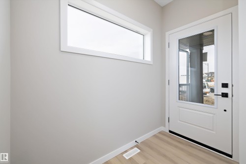 Doorway featuring wood finished floors and baseboards - 4544 Kinsella Link, Edmonton, AB - Indoor Photo Showing Other Room