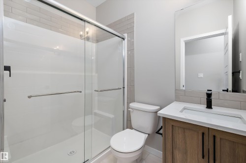 Full bath featuring vanity, a shower stall, and light tile patterned floors - 4544 Kinsella Link, Edmonton, AB - Indoor Photo Showing Bathroom