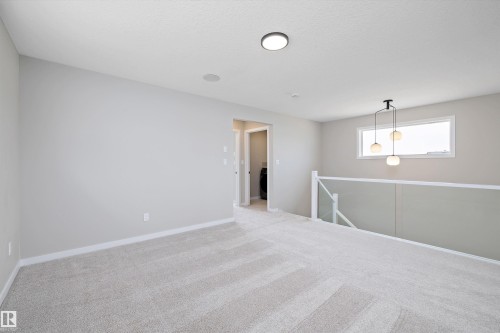 Unfurnished room featuring carpet floors and baseboards - 4544 Kinsella Link, Edmonton, AB - Indoor Photo Showing Other Room