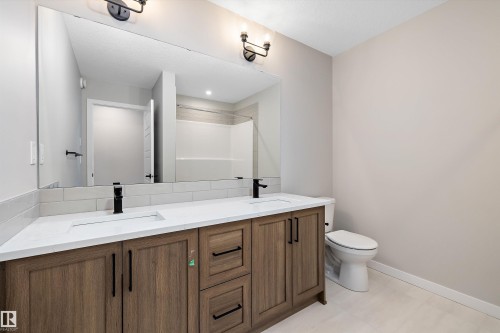 Full bathroom featuring double vanity and a shower - 4544 Kinsella Link, Edmonton, AB - Indoor Photo Showing Bathroom