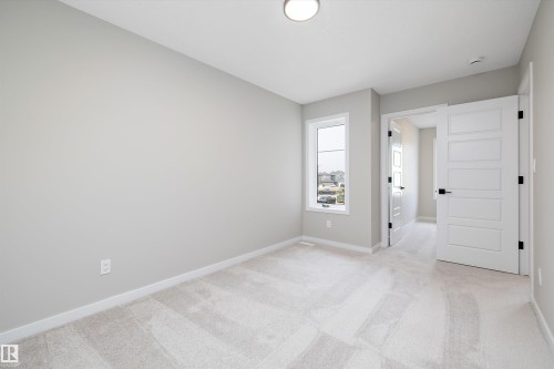 Spare room with light colored carpet and baseboards - 4544 Kinsella Link, Edmonton, AB - Indoor Photo Showing Other Room