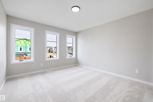 Spare room with light carpet and baseboards - 4544 Kinsella Link, Edmonton, AB - Indoor Photo Showing Other Room
