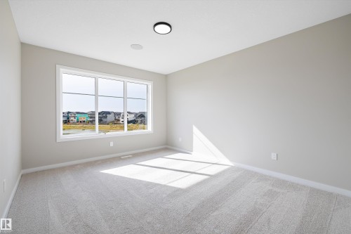 Unfurnished room with light carpet - 4544 Kinsella Link, Edmonton, AB - Indoor Photo Showing Other Room