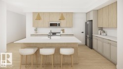 Kitchen with pendant lighting, light brown cabinetry, high quality fridge, a kitchen island with sink, and white microwave - 