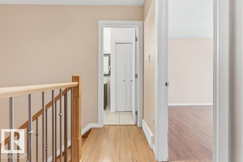Corridor featuring an upstairs landing and light wood finished floors - 196 Roseland Village, Edmonton, AB - Indoor Photo Showing Other Room